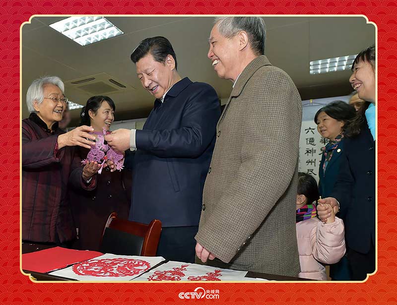 2015年2月15日,習(xí)近平在西安市雁塔區(qū)電子城街道二〇五所社區(qū)服務(wù)中心欣賞社區(qū)居民的剪紙作品。